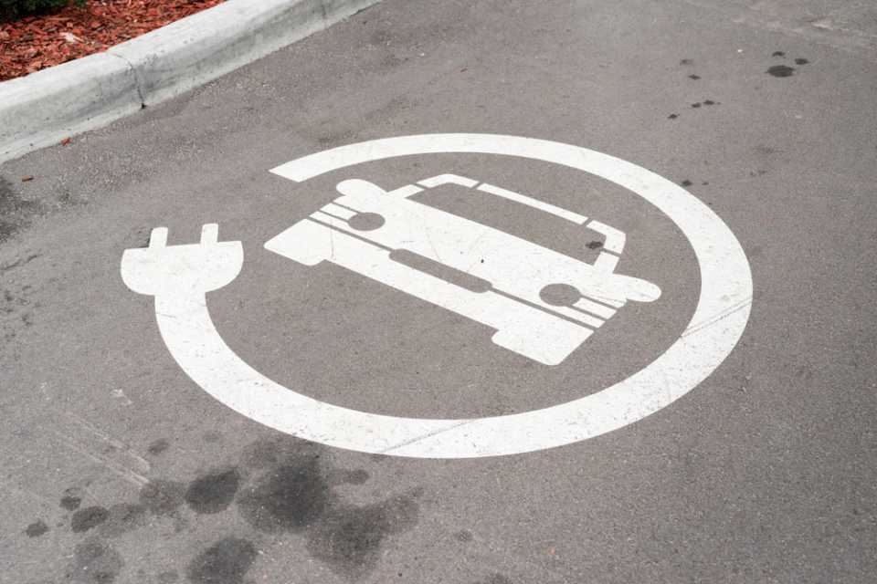 EV charging sign on asphalt