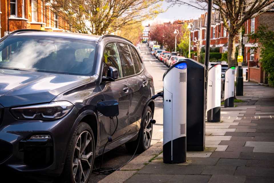 An EV being charged at the side of the road.